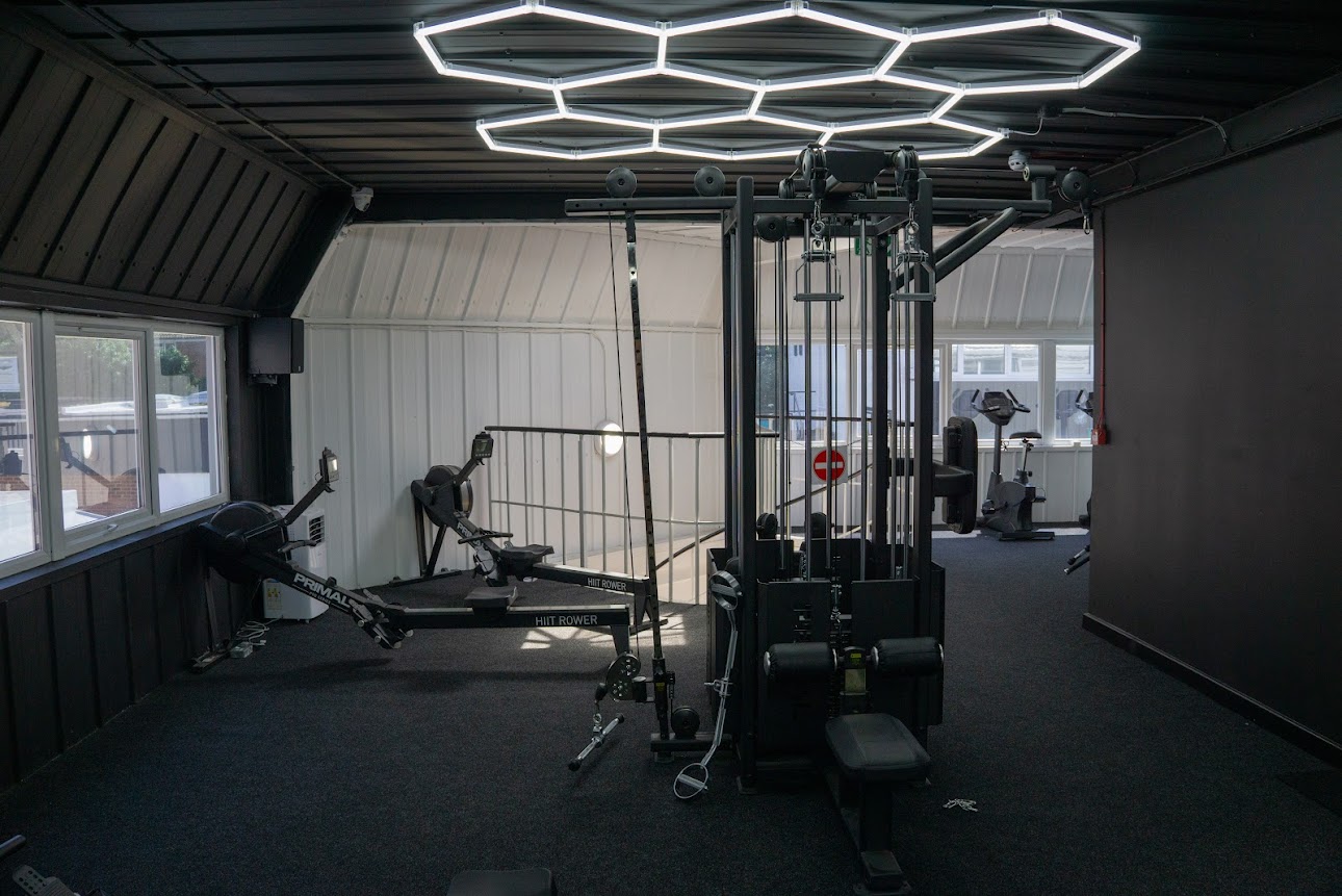 Functional training area with HIIT rowers and cable machine